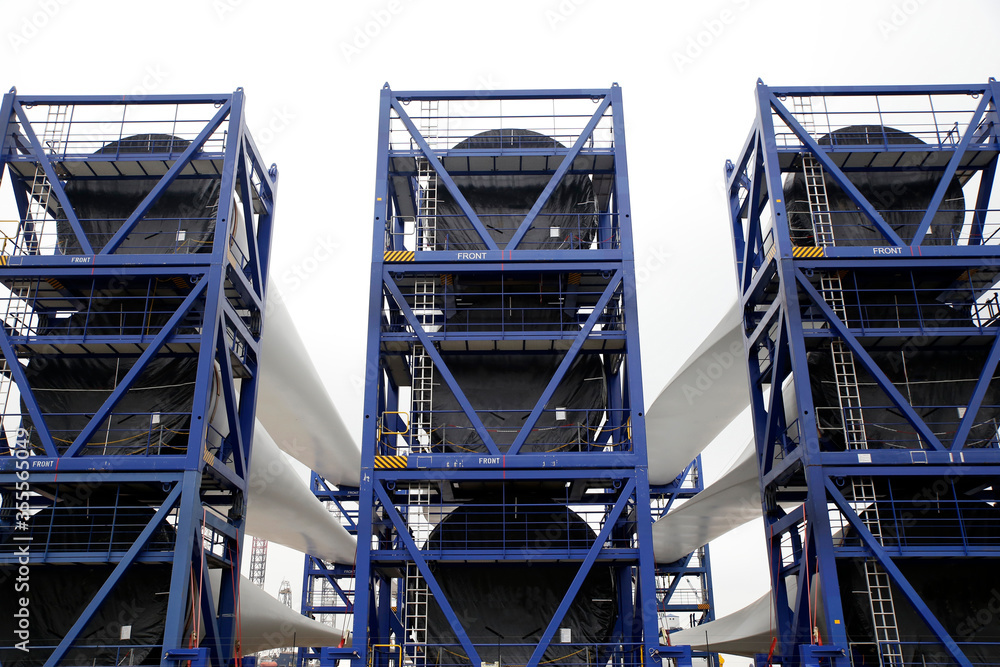 Newly constructed wings of wind-turbines ready to be transported to an offshore windpark, Holland