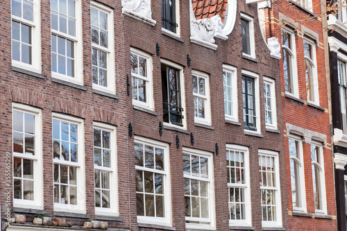 Horizontal full-frame, detail view of classic, traditional red brick buildings in Amsterdam. Classic residential architecture in the capital of The Netherlands under soft even light