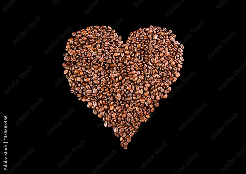 Coffee beans arranged in a shape of heart on black background Coffee beans arranged in a shape of heart on black background