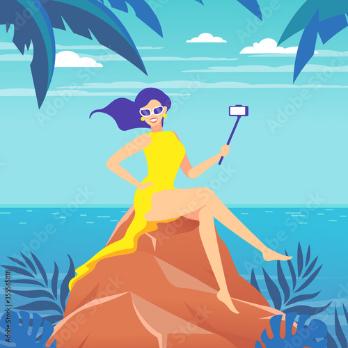 A woman takes a selfie, videotaping with the help of a selfie stick against the background of the sea landscape.