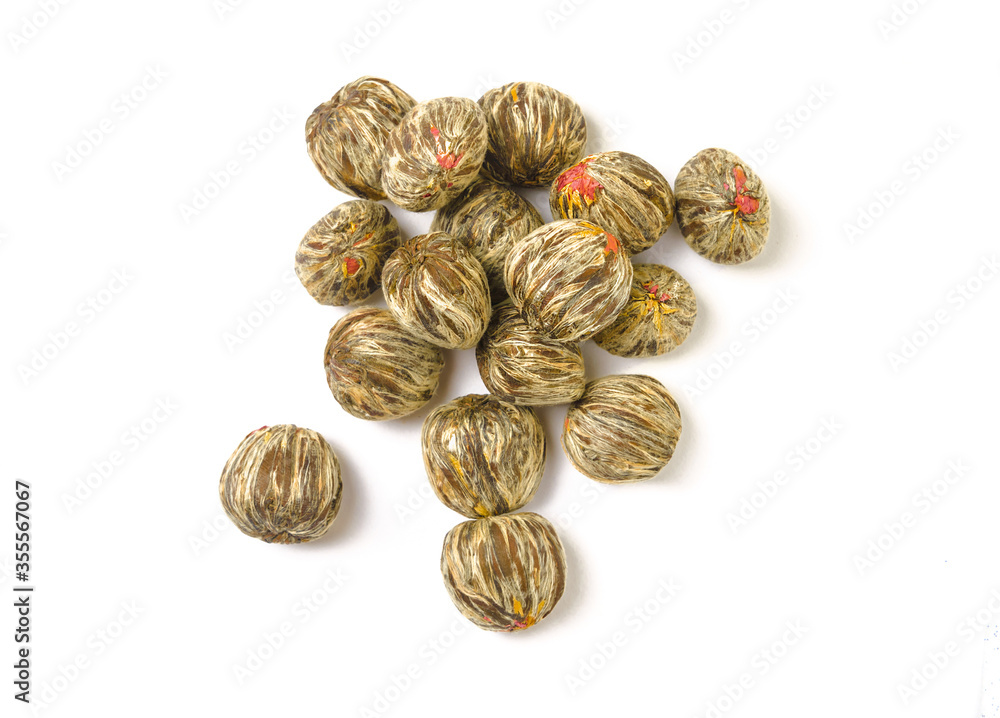 Flower Bud Tea. A ball of flower tea on a white background. Green tea with Jasmine. Knitted dry tea Bud. Flower Bud Tea. A ball of flower tea on a white background. Green tea with Jasmine. Knitted dry tea Bud.