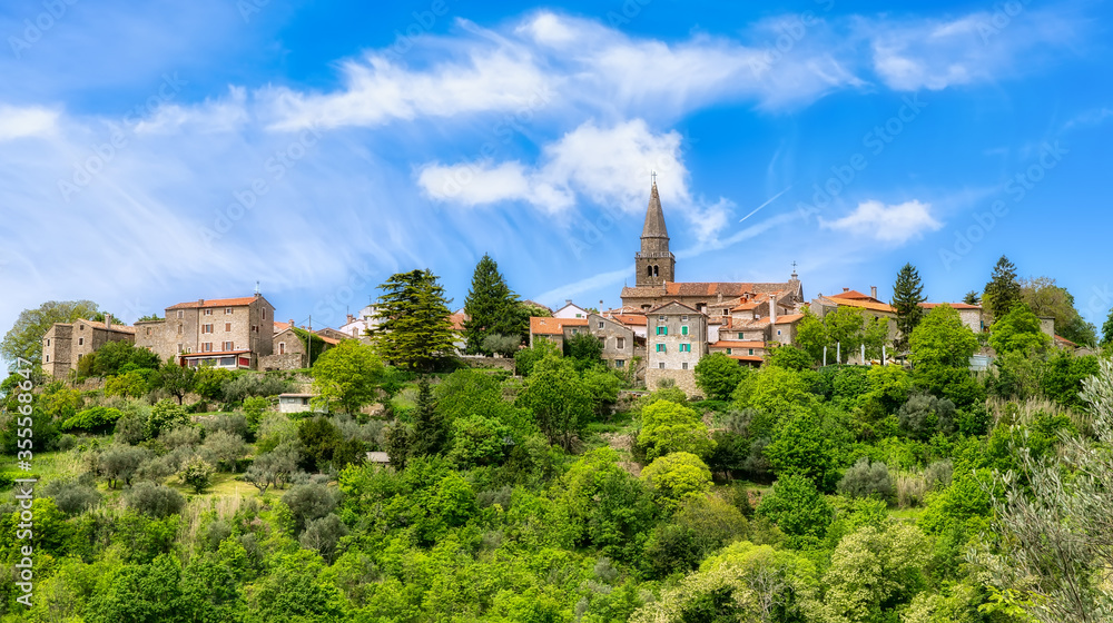 View on small town Groznjan in Croatia on a sunny day with blue sky and clouds
