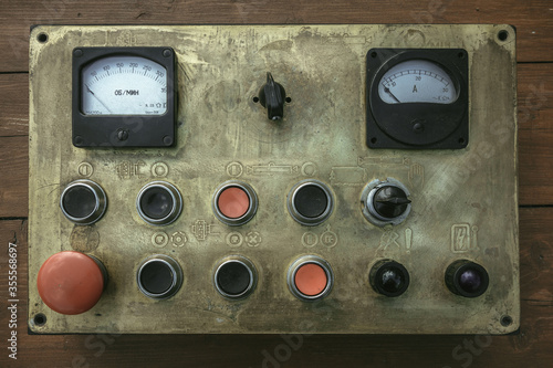 Old brass machine control panel with buttons and indicators photo