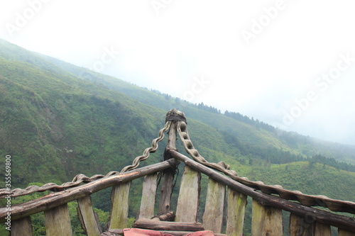 wooden boats located in the hills for tourist photos. wooden ship with a background in the peak of Mount Arjuno-Welirang, Indonesia photo