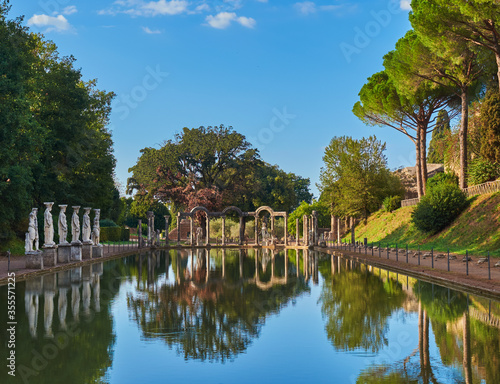 Valokuva The Ancient Pool Canopus, surrounded by pine trees and greek sculptures in Hadri