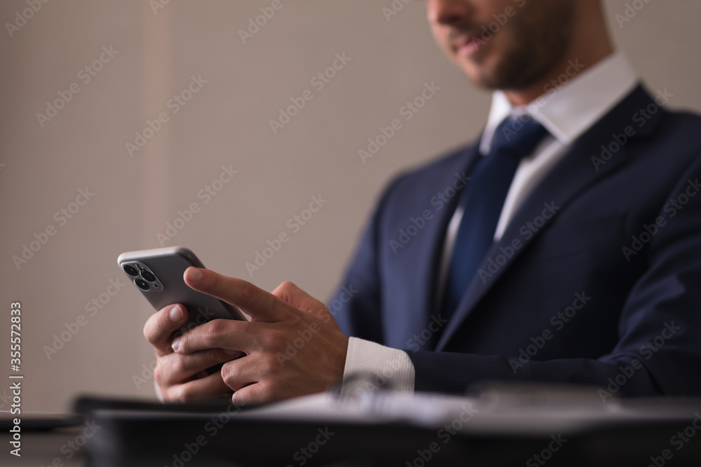 Young business man typing on the phone Young business man typing on the phone