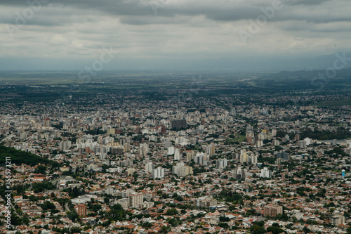 Aerial panorama view of the city Salta  in Argentina  at the foot of the mountains. Many concrete buildings in the valley under a cloudy sky