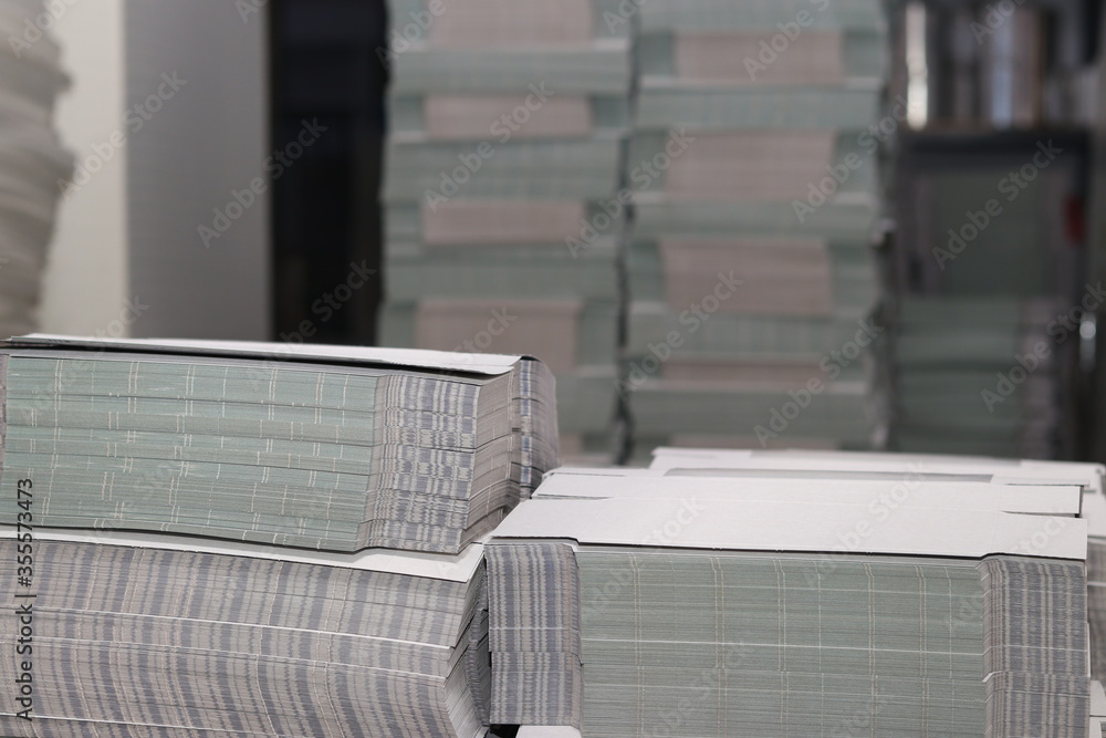 stacks of printed sheets of cardboard on wooden pallets closeup. printing industry stacks of printed sheets of cardboard on wooden pallets closeup. printing industry