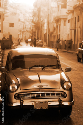 A classic car driving in a street in Havana. These old and classic cars are an iconic sight of the island