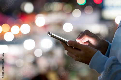 point finger on screen phone closeup, person texting text message, hipster touch blue screen on smartphone light night city, girls using in hands mobile phone close up, online wi-fi