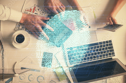 Double exposure of man and woman working together and fingerprint drawing. Computer background. Top View. Security concept.