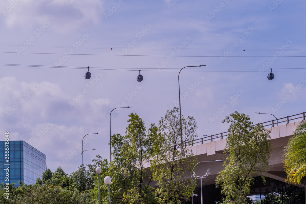 Three cable cars above overpass