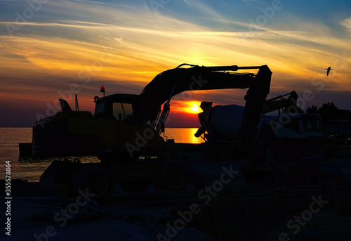 Silhouette Earth Mover On Land Against Sky During Sunset