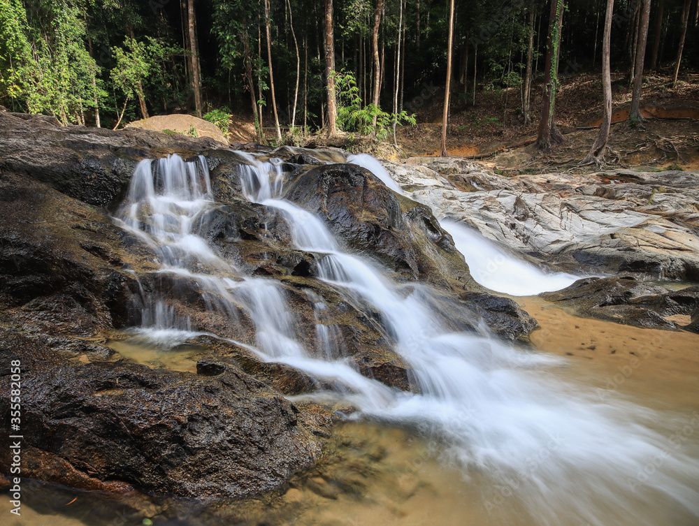 Fototapeta premium Waterfall found in tropical rainforest in malaysia
