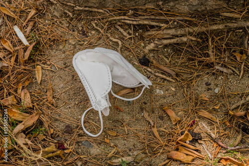 Принти на полотні White medical face mask mask on ground.