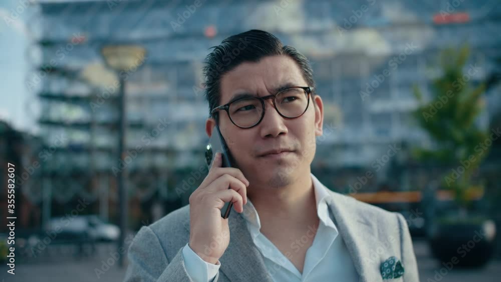 Successful Businessman Talking Business on his Smartphone in the City Successful Businessman Talking Business on his Smartphone in the City