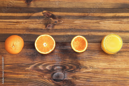 Fresh juicy oranges from above on wood table. Empty ready for your orange juice, fruit product display or montage.