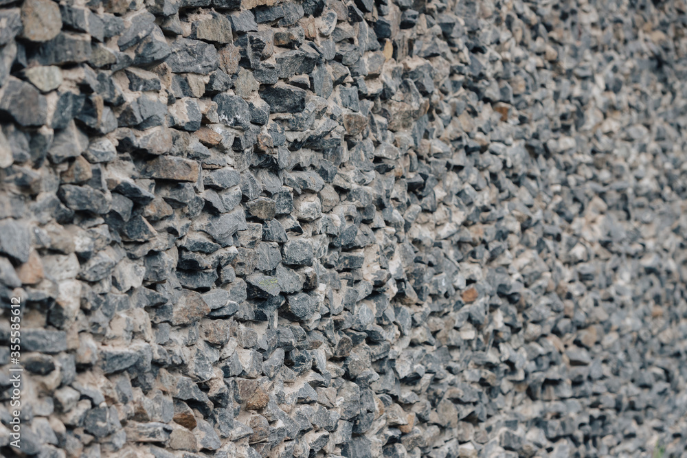 Stone wall. Detailed texture of a wall lined with cobblestones with cement. Stone wall. Detailed texture of a wall lined with cobblestones with cement.