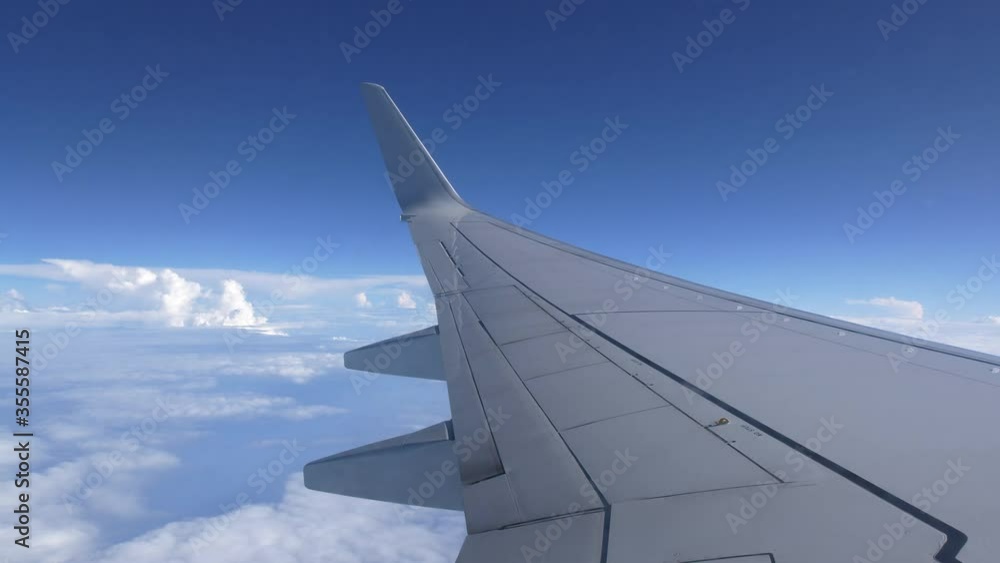 Blue cloudy sky from the window of a commercial airplane, filmed with a super wide angle lens in UHD Blue cloudy sky from the window of a commercial airplane, filmed with a super wide angle lens in UHD