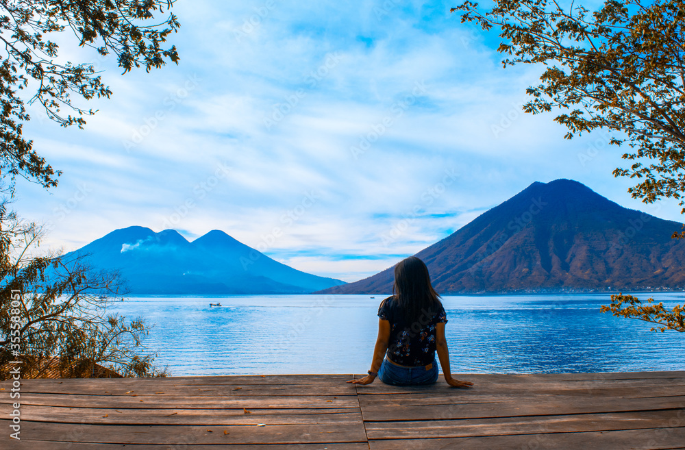 girl admires view of the  lake and beautiful landscape