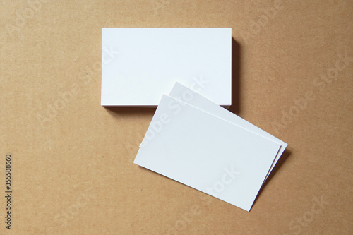 Business card on colored background. Blank name card for company logo,  Branding Mock-up. Flat lay. Copy space for text        © redtiger9
