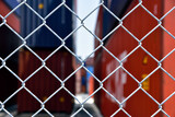 Wire mesh fence enclosing the maritime transport terminal: shipping industry