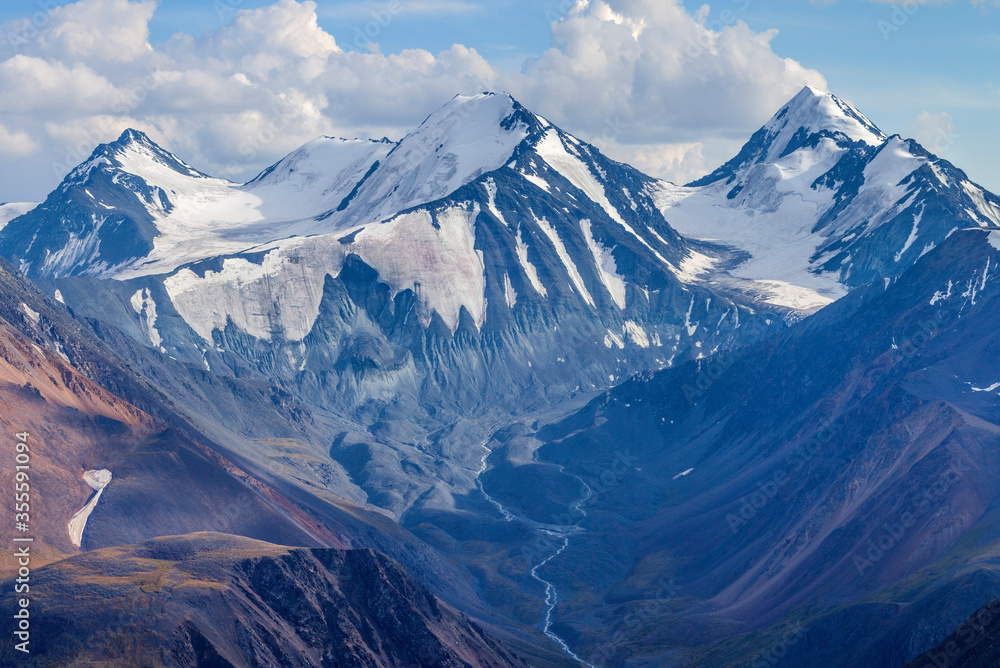 Mountain landscape. Snow-capped peaks, glaciers. Mountain climbing and mountaineering.