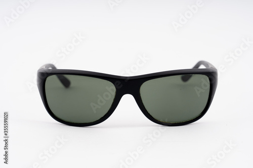 black plastic sunglasses on white background. selective focus.