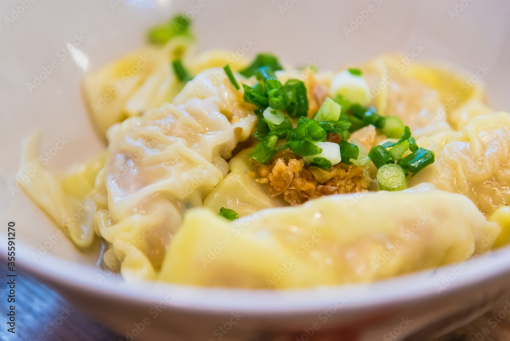 Vegetable & Pork Wontons with spicy sauce and green onion.