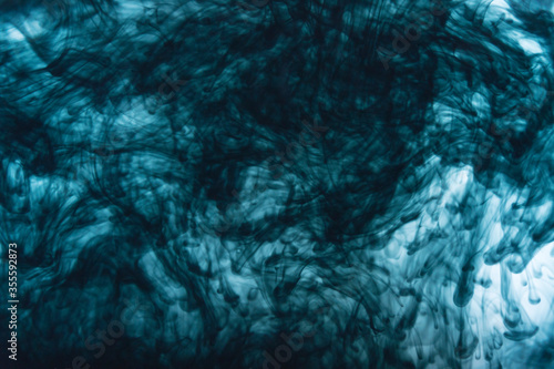 Black ink color dripping in water
