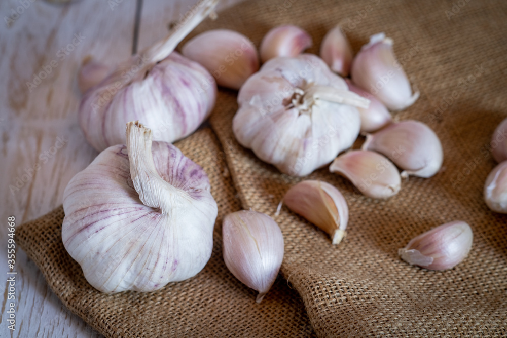 Garlic cloves and garlic on a wooden table. Garlic cloves and garlic on a wooden table.