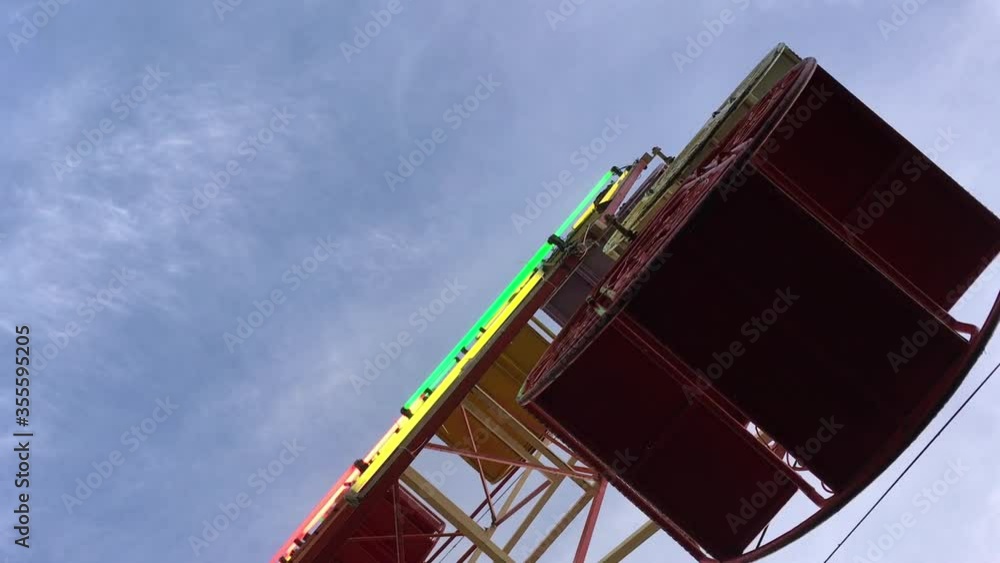 Underside view of a ferris wheel with blue sky Underside view of a ferris wheel with blue sky