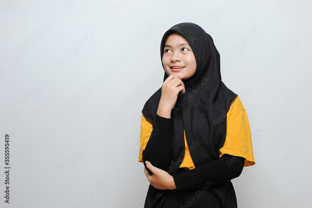 Portrait of Cute Young Asian Muslim woman smiling looking at copy space Portrait of Cute Young Asian Muslim woman smiling looking at copy space