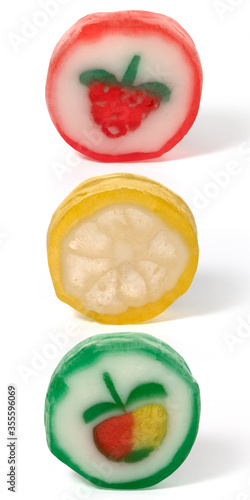 Three round fruit caramels on a white background