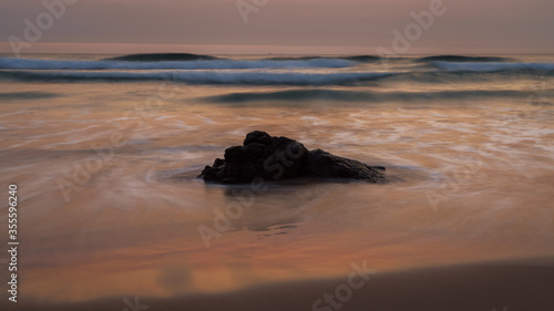 Rock with water movement at dawn