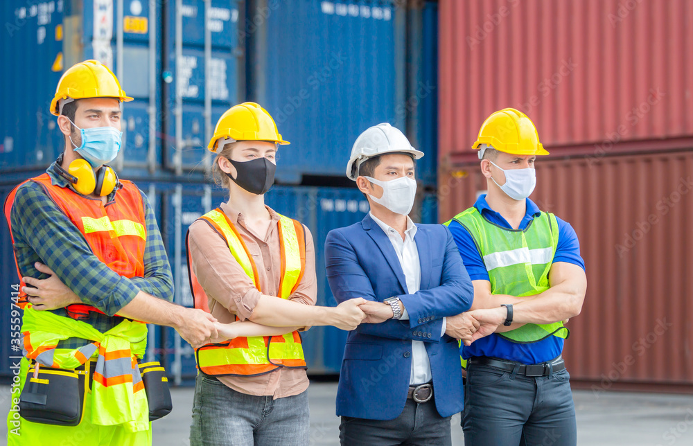 Business people engineer and worker team wearing protection face mask against coronavirus, meeting holding hands together in line, Success and Teamwork Concept Business people engineer and worker team wearing protection face mask against coronavirus, meeting holding hands together in line, Success and Teamwork Concept