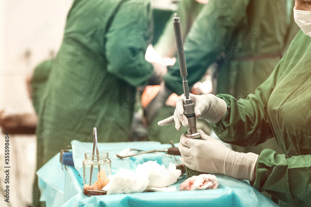Orthopaedic surgery instrument tray inside the operating room. hip replacement surgery in progress. Medical concept Orthopaedic surgery instrument tray inside the operating room. hip replacement surgery in progress. Medical concept