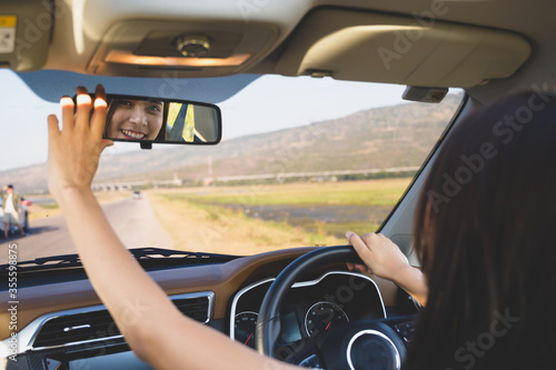 Asian woman driving  a car