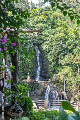 Layana waterfall in the jungle in Ubud. Gianyar, Bali, Indonesia. Tropical lush landscape. Destination holidays. Vertical image. photo