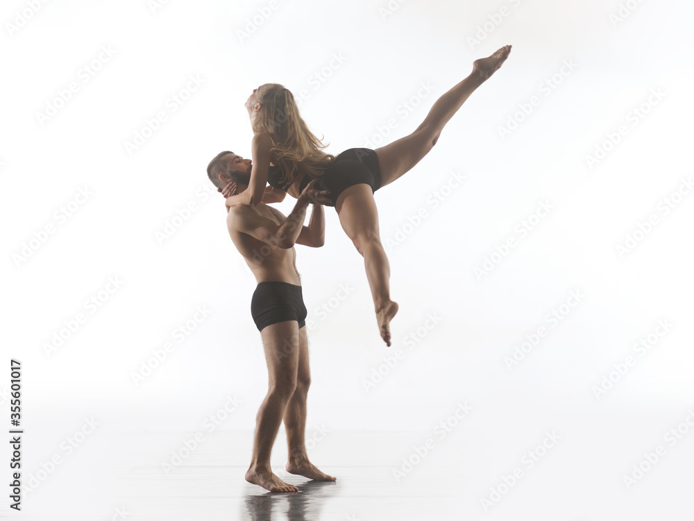couple of athletic dance partners in front of white background couple of athletic dance partners in front of white background