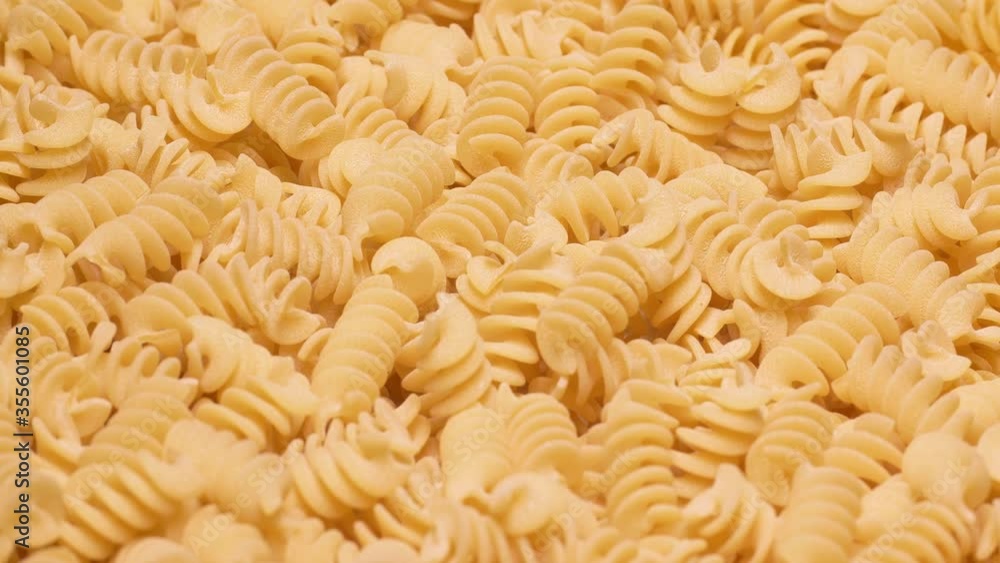 Closeup graded 60 fps shot of the dry Fusilli pasta on a turntable, filmed with a macro lens in UHD Closeup graded 60 fps shot of the dry Fusilli pasta on a turntable, filmed with a macro lens in UHD