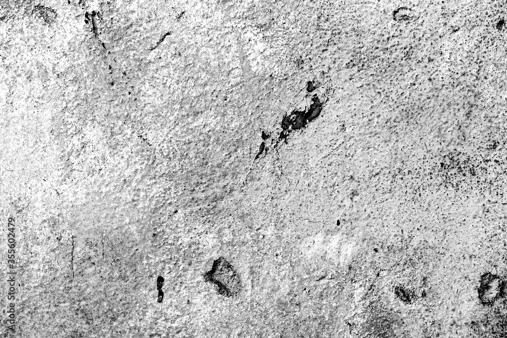 Texture of a concrete wall with cracks and scratches which can be used as a background Texture of a concrete wall with cracks and scratches which can be used as a background