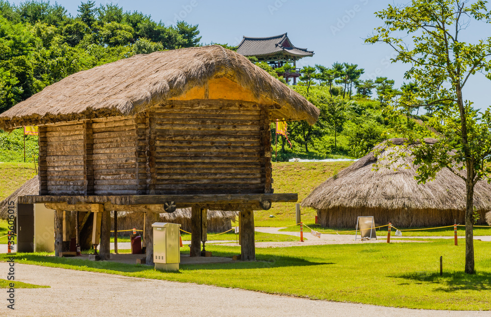 Log building with straw thatch roof Log building with straw thatch roof
