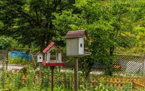 White birdhouses in garden © aminkorea