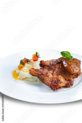 Roast Chicken served with mashed potatoes smothered in melted cheese sauce and garnish, isolated on white.
