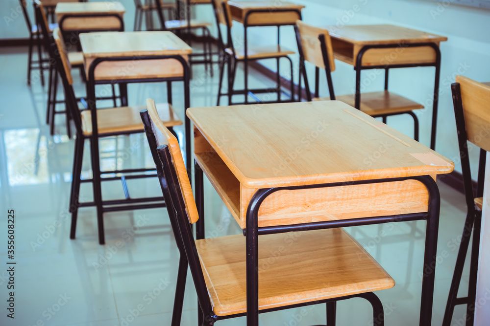 Back to school concept. School empty classroom, Lecture room with desks and chairs iron wood for studying lessons in highschool thailand without young student, interior of secondary education Back to school concept. School empty classroom, Lecture room with desks and chairs iron wood for studying lessons in highschool thailand without young student, interior of secondary education