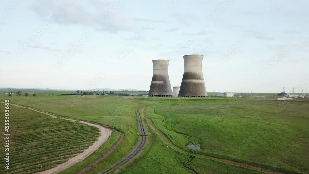 Man holding smoke grenade in front of nuclear power plant Man holding smoke grenade in front of nuclear power plant