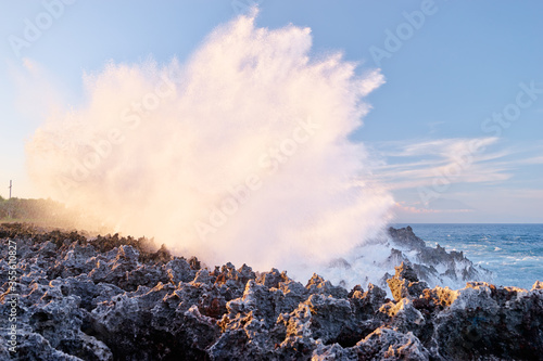Powerful waves splashing over coral reef on the beach. Indonesia, Bali