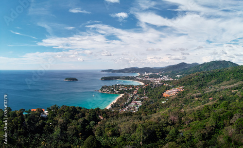 Kata and Karon beach view point. Beautiful landscape with ocean shore, green hills, cloudy sky. Phuket, Thailand.