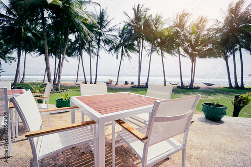 Table in resort cafe on the tropical sea beach with beautiful view. © luengo_ua